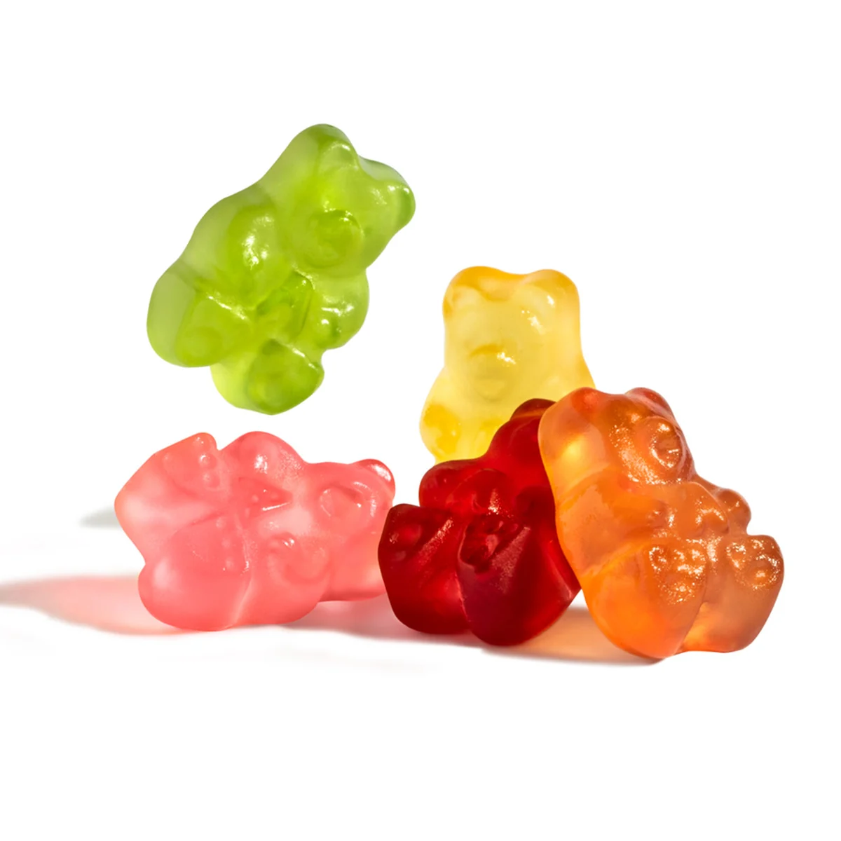 Colorful gummy bears on a white surface