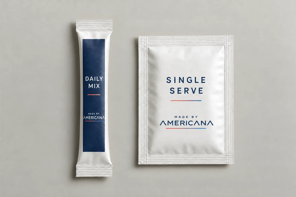 Made By Americana daily mix stick pack beside a single-serve sachet