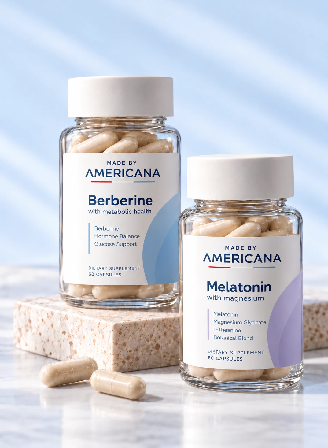 Made By Americana Berberine and Melatonin capsule bottles on stone plinths with loose capsules